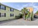Yellow home with outdoor seating area, stairway to unit, and gravel parking area at 5 1/2 Kracke St # A, Charleston, SC 29403