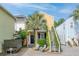 Charming yellow home with outdoor seating area, lush landscaping, and stairway to unit at 5 1/2 Kracke St # A, Charleston, SC 29403