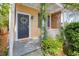 Cozy front porch with a wreath on the door, and natural landscaping at 5 1/2 Kracke St # A, Charleston, SC 29403