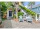 Inviting front yard with brick, exterior stairs, seating, and lush greenery offers a warm welcome at 5 1/2 Kracke St # A, Charleston, SC 29403