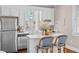 Well-lit eat-in kitchen boasting stainless steel appliances, marble countertops and bar stool seating at 5 1/2 Kracke St # A, Charleston, SC 29403