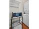 A compact laundry room with stacked washer/dryer, microwave, and convenient shelving at 5 1/2 Kracke St # A, Charleston, SC 29403