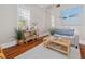 Cozy living room with natural light, hardwood floors, and stylish rattan furniture at 5 1/2 Kracke St # A, Charleston, SC 29403