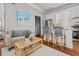 Comfortable living room featuring a sofa, rattan coffee table, hardwood floors and an eat-in kitchen at 5 1/2 Kracke St # A, Charleston, SC 29403