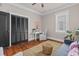 Inviting sitting room with desk area, hardwood flooring, and neutral decor at 5 1/2 Kracke St # A, Charleston, SC 29403