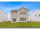 Light siding two-story home with large windows and a sliding glass door leading to the backyard at 525 Purple Finch Rd, Summerville, SC 29486