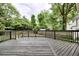 Spacious wooden back deck with railing and view of the yard and surrounding trees at 5359 Curtisston Ct, North Charleston, SC 29418