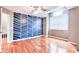 A bedroom with hardwood floors, a ceiling fan, and an accent wall with a geometric pattern at 5359 Curtisston Ct, North Charleston, SC 29418