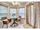 Bright breakfast nook with a cozy table and chairs, surrounded by windows, offering a serene dining experience at 5359 Curtisston Ct, North Charleston, SC 29418