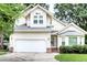 Charming two-story home featuring a two-car garage, a well-manicured lawn, and classic suburban curb appeal at 5359 Curtisston Ct, North Charleston, SC 29418