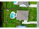 Aerial view showcases the house, pool and landscaping in a well-maintained fenced backyard at 5509 Alpine Dr, Summerville, SC 29483