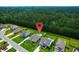 Stunning aerial view of homes and lush greenery featuring a sparkling community pool at 5509 Alpine Dr, Summerville, SC 29483