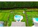 Aerial view of a private pool with beautiful landscaping in a fenced backyard near a wooded area at 5509 Alpine Dr, Summerville, SC 29483