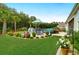Lush backyard featuring a pool, patio furniture, and well-manicured landscaping at 5509 Alpine Dr, Summerville, SC 29483
