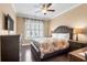 Cozy bedroom featuring a ceiling fan and a window with plantation shutters for natural light at 5509 Alpine Dr, Summerville, SC 29483