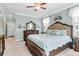 Bright bedroom with a large bed, ceiling fan, a dresser with a mirror, and natural light at 5509 Alpine Dr, Summerville, SC 29483