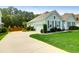 Exterior view of a home featuring a well-kept lawn and a driveway leading to the garage at 5509 Alpine Dr, Summerville, SC 29483