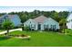 Charming single-story home with a well-manicured lawn, landscaping, and black shutters at 5509 Alpine Dr, Summerville, SC 29483