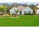 Charming single-story home with a well-manicured lawn, landscaping, and a palm tree at 5509 Alpine Dr, Summerville, SC 29483