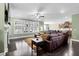Bright living room features a fireplace, ceiling fan, hardwood floors, and lots of natural light at 5509 Alpine Dr, Summerville, SC 29483