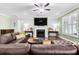 Bright living room features a fireplace, ceiling fan, hardwood floors, and lots of natural light at 5509 Alpine Dr, Summerville, SC 29483
