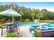 Backyard pool area with stylish outdoor furniture, lush landscaping, and a private retreat setting at 5509 Alpine Dr, Summerville, SC 29483