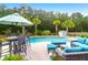 Backyard pool area with stylish outdoor furniture, lush landscaping, and a private retreat setting at 5509 Alpine Dr, Summerville, SC 29483
