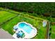 An aerial view of a backyard pool with turquoise water, lounge furniture, and decorative landscaping at 5509 Alpine Dr, Summerville, SC 29483
