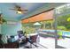 Inviting outdoor porch with ceiling fan, comfortable furniture, and serene pool view at 5509 Alpine Dr, Summerville, SC 29483