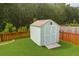 Backyard shed in a wooded backyard with green grass and wood fence at 5509 Alpine Dr, Summerville, SC 29483