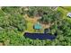 Aerial shot of a home with green roof nestled in trees with pond and private dock at 5519 Jefferies Hwy, Walterboro, SC 29488
