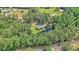 Wide aerial shot showcases a secluded home with pond, surrounded by forest and serene landscape at 5519 Jefferies Hwy, Walterboro, SC 29488