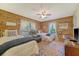 Cozy bedroom with wood-paneled walls, two beds, a ceiling fan and bright natural light at 5519 Jefferies Hwy, Walterboro, SC 29488
