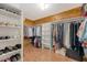 Spacious walk-in closet features wood-paneled walls, shelving, and ample hanging space for clothes and accessories at 5519 Jefferies Hwy, Walterboro, SC 29488