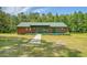 Cozy cabin-style home with a green metal roof, inviting walkway and landscaped front yard at 5519 Jefferies Hwy, Walterboro, SC 29488