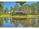 Scenic lakefront home featuring a covered porch and serene water views at 5519 Jefferies Hwy, Walterboro, SC 29488