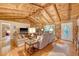 Comfortable living room with wood-paneled walls, a stone fireplace, hardwood floors, and cozy seating at 5519 Jefferies Hwy, Walterboro, SC 29488