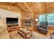 Inviting living room featuring a stone fireplace, hardwood floors, comfortable seating, and natural light at 5519 Jefferies Hwy, Walterboro, SC 29488