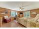 Relaxing bedroom with ceiling fan, hardwood floors, desk area, and a quaint red arm chair at 5519 Jefferies Hwy, Walterboro, SC 29488
