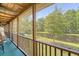 Relaxing screened-in patio with comfortable seating and serene views of the lush backyard and pond at 5519 Jefferies Hwy, Walterboro, SC 29488