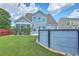 Landscaped backyard with a pool, lush grass, and vinyl siding at 575 Rosings Dr, Summerville, SC 29486