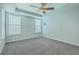 Bright bedroom with gray carpet, tray ceiling, a ceiling fan, and plenty of natural light at 575 Rosings Dr, Summerville, SC 29486
