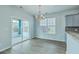 Bright dining area features modern lighting, wood flooring, and sliding door to the outdoor patio at 575 Rosings Dr, Summerville, SC 29486