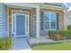Inviting front entrance with stone accents, manicured shrubs, and a stylish front door at 575 Rosings Dr, Summerville, SC 29486