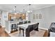Spacious dining room adjacent to the kitchen, complemented by a hardwood floor and a stylish light fixture at 622 Windermere Blvd # D, Charleston, SC 29407