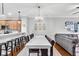 Open concept dining area with breakfast bar, a bright chandelier, and hardwood floors at 622 Windermere Blvd # D, Charleston, SC 29407
