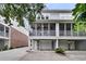 Home exterior featuring a screened porch, garage, and well-manicured landscaping at 622 Windermere Blvd # D, Charleston, SC 29407