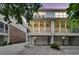 Exterior view of home shows screened porch, garage, and yard with trees at dusk at 622 Windermere Blvd # D, Charleston, SC 29407