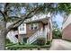 Charming brick townhome with white stairs, lush landscaping, and mature trees, offering curb appeal at 622 Windermere Blvd # D, Charleston, SC 29407