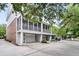 Exterior view of home shows screened porch, garage, and yard with trees and driveway at 622 Windermere Blvd # D, Charleston, SC 29407